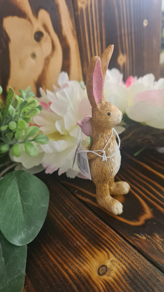 Bunny Holding rose behind Back